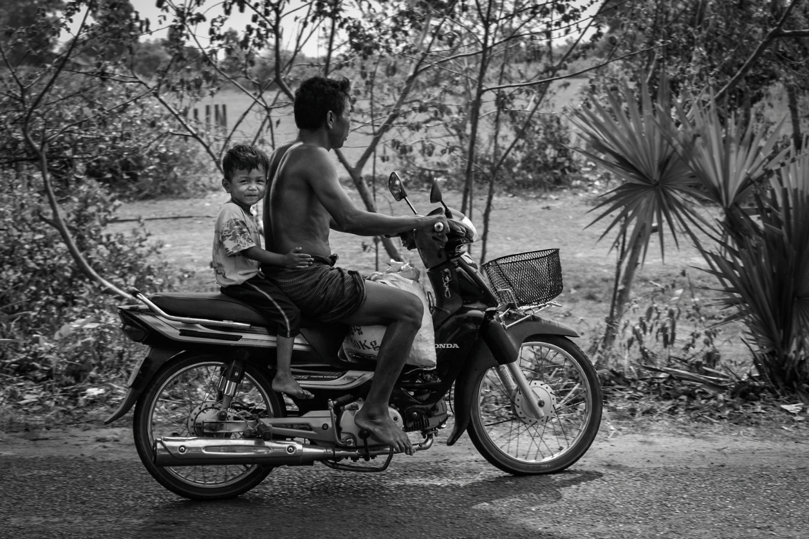 Cambodia photo tours Angkor Wat father and son on a motorbike
